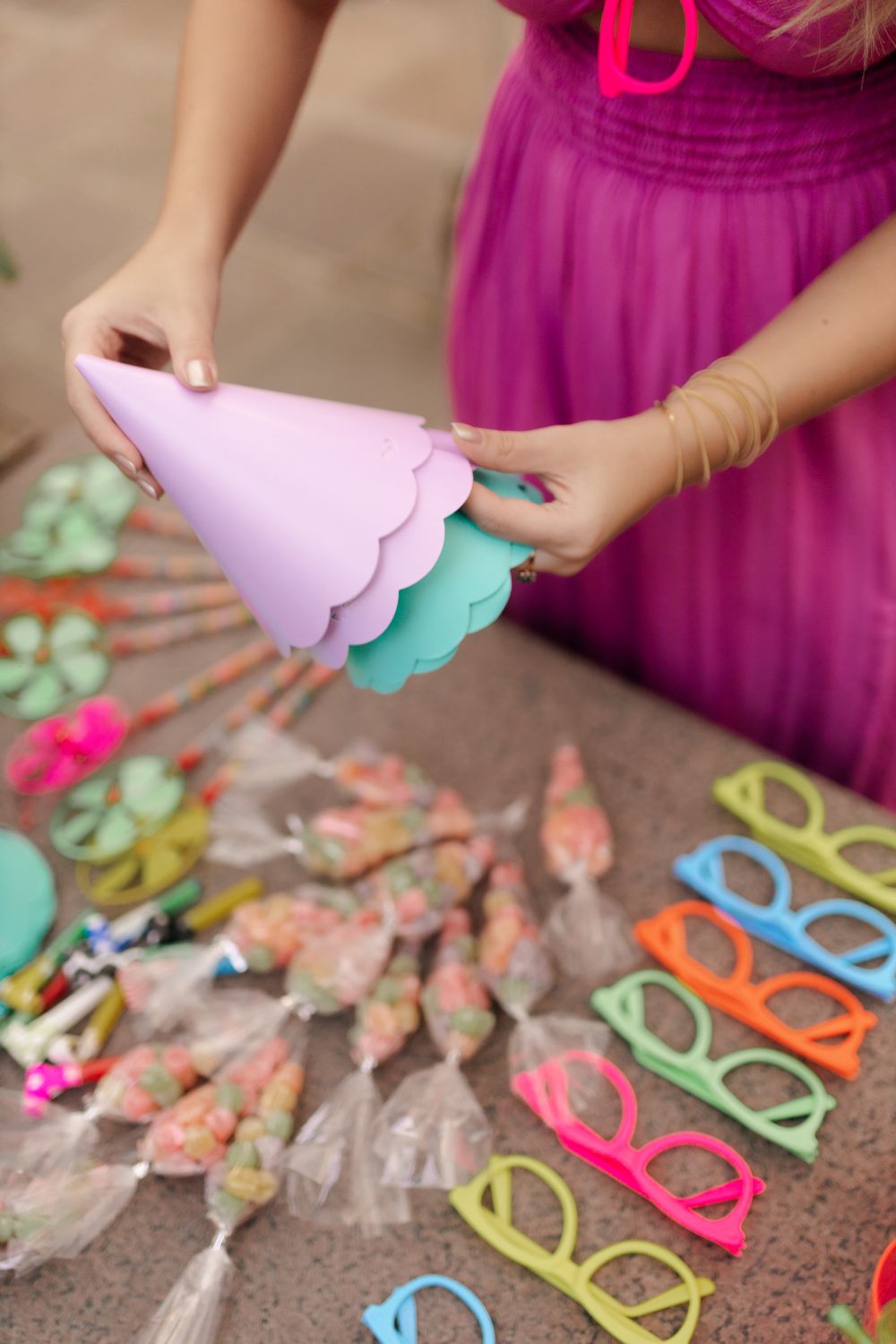 Colourful party hats and novelty glasses laid out on a table