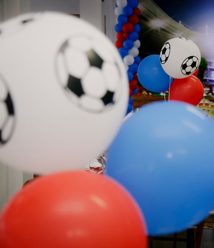Soccer ball balloons above a party table